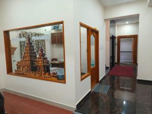 a room with a picture of a statue on a wall at Srinivasa Paradise in Mahabalipuram