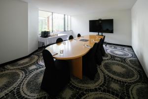 a conference room with a wooden table and chairs at The Leea, Darwin in Darwin
