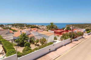 a view from the balcony of a house with the ocean at Villa Pearla by Villa Plus in Cala en Porter