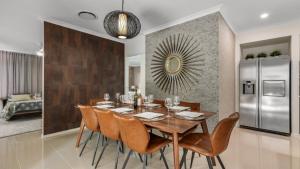 a dining room with a table and a refrigerator at The Cabana Oasis in Woorim +16 photos