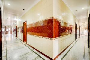 a hallway with tiles on the walls of a building at Collection O Vadapalani Formerly Mahalakshmi Inn in Chennai