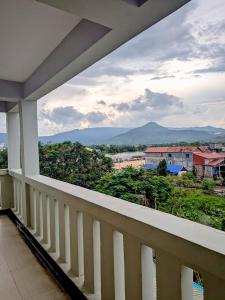 a balcony with a view of a city at AHHA Residence Kampot in Phumĭ Bœ̆ng Phlŏng (2)