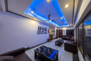 a living room with couches and a blue ceiling at Hotel La Park, Leh in Leh