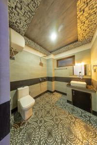 a bathroom with a toilet and a sink at Hotel La Park, Leh in Leh +25 photos