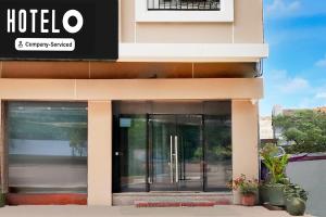 a hotel with glass doors on a building at Hotel O Tehsil Chowk Doon Hospital Formerly Hotel Comfort in Dehradun
