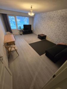 a living room with a couch and a table at Mudita Apartment in Mikkeli