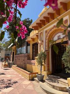 a building with a potted tree in front of it at Janki Vilas in Orchha