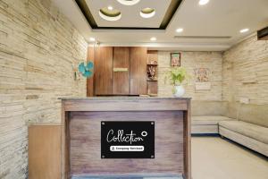 a lobby with a reception desk and a couch at Collection O Rispana Pul Dehradun Formerly Hotel Square 1 in Clement Town
