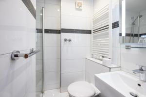 a bathroom with a shower and a toilet and a sink at Hotel Am Martinsberg in Andernach +58 photos