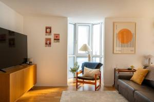 a living room with a couch and a chair at Central12 Apartment - Free Parking in Thun