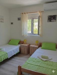 a bedroom with two beds and a window at Vila Rogač in Tivat +109 photos