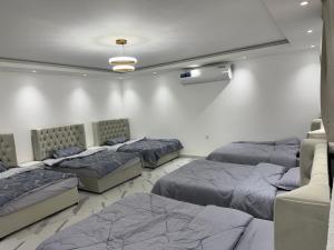 a room with three beds and a couch at استرحه ام الحمام in Suḩaybah +50 photos