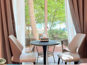 a table with a cake sitting on top of a window at Samma Karuna Beach & Wellness Resort - Intoxicants free in Srithanu