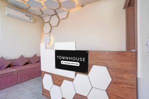 a room with a couch and a sign that reads townhouse at Townhouse Govardhan in Govardhan
