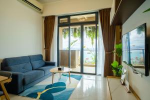 a living room with a blue couch and a table at Best Hotel in Johor Bahru