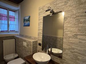 a bathroom with two sinks and a mirror at Il Torchio - Guest House Lago Maggiore in Dormelletto +45 photos