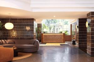 a living room with a couch and a table at Silom Serene A Boutique Hotel in Bangkok