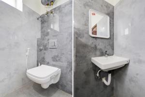 a bathroom with a white toilet and a sink at Super Collection O Vanasthalipuram in Hyderabad