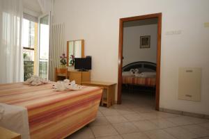 Postel nebo postele na pokoji v ubytování Hotel Lugano