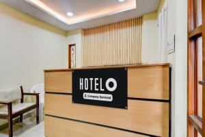a hotel lobby with a hotel sign on the wall at Hotel O Lakdikapul Near Birla Mandir in Hyderabad