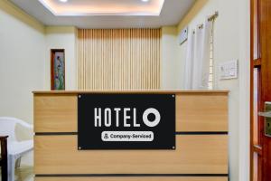 a hotel sign on top of a reception desk at Hotel O Lakdikapul Near Birla Mandir in Hyderabad +38 photos