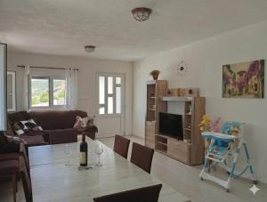 a living room with a couch and a table at Vila Rogač in Tivat