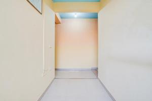 an empty hallway with white walls and a blue ceiling at Super Hotel O JLN Marg Malviya Nagar Formerly Hotel Braj Haveli in Jaipur +42 photos