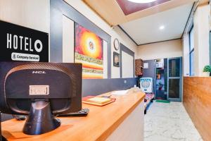 a hotel desk with a computer on top of it at Super Hotel O JLN Marg Malviya Nagar Formerly Hotel Braj Haveli in Jaipur