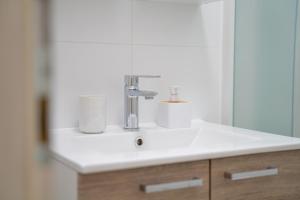 a bathroom sink with a faucet and a mirror at Nikola studio in Božava