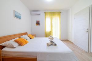a bedroom with a bed with a teddy bear on it at Nikola studio in Božava +1 photo