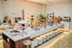 a buffet line with plates and bowls of food at DAO NGOC BEACH HOTEL Da Nang in Danang
