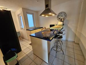 a kitchen with a black counter top in a room at Stadtperle in Göppingen +4 photos