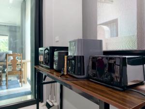 four microwaves on a counter in a kitchen at Tanner House Krabi in Ban Klang