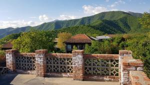 a brick fence with a view of a mountain at AnaVino in Kvareli