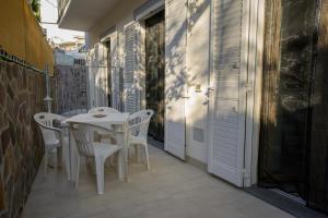 a white table and chairs on a balcony at Danys home in Ischia Town