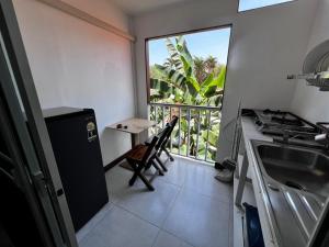 a kitchen with a balcony with a table and a stove at Ko Lipe Appartamenti in Ko Lipe