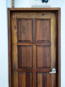 a wooden door with a sign on top of it at Ko Lipe Appartamenti in Ko Lipe