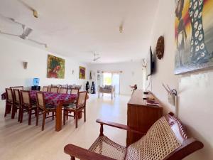 a living room with a dining room table and chairs at Villa Gladys in Watamu