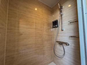 a bathroom with a shower with a shower head at 2four Villa Costa in Minamiise +43 photos