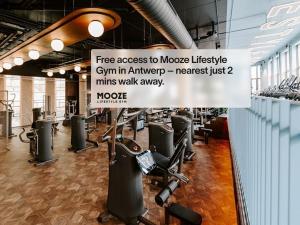 a gym with a sign that reads free access to mooseike gym in ant at Numa Antwerp Opera in Antwerp