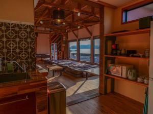 a room with a kitchen with a view of the ocean at 2four Villa Costa in Minamiise