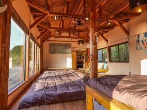 a bedroom in a tree house with a large bed at 2four Villa Costa in Minamiise