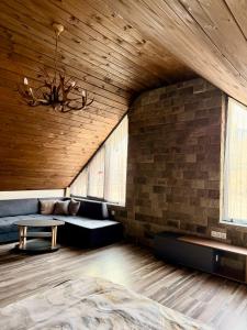 a living room with a couch and a table at Guest House ELIYA in Devin