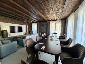 a dining room with a long table and chairs at Guest House ELIYA in Devin