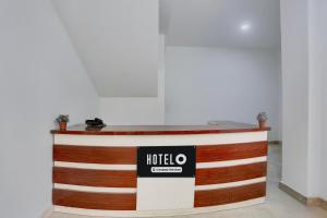 a reception desk with a hotel sign on it at Hotel O Model Town Road in Manāli