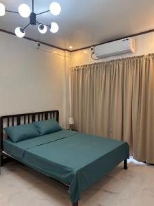a bedroom with a bed and a air conditioner at Casa Villa Gracia in Bigaa +24 photos