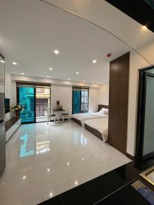 a bedroom with a bed and a desk in it at Fuji Apartment in Hanoi +32 photos