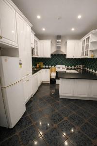 a kitchen with white cabinets and black counter tops at Hahndorf Motel in Hahndorf