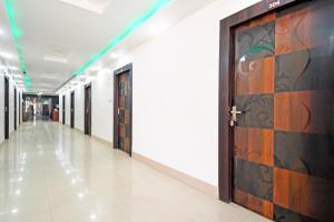an empty hallway with a door in a building at Super Collection O Raja Bazar Bailey Road in Patna +40 photos