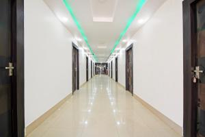 a corridor in a building with a green ceiling at Super Collection O Raja Bazar Bailey Road in Patna